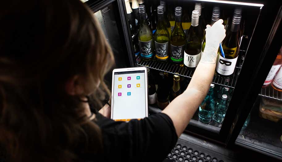 restaurant employee checking inventory of wine